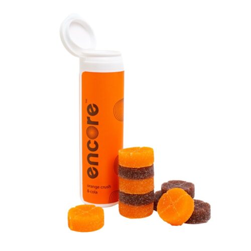 An image of Encore Edibles 600mg THC Orange Soda and Cola Gummies in their tube packaging with some stacked in front of it to showcase the gummies