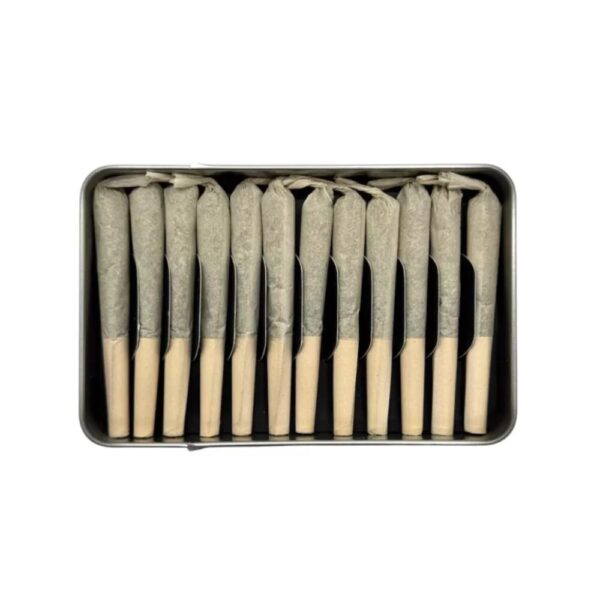 Open tin of Now + Then SATIN Sativa Pre Roll 12 Pack – Snow Drop showing twelve neatly arranged slim 0.5g pre rolls with citrus-floral themed design