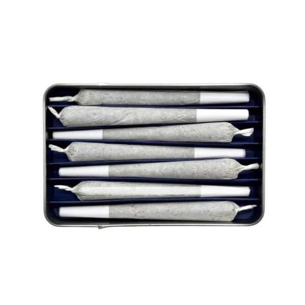 Open tin of Now + Then TINDICA Indica Pre Roll 7 Pack – Lemon Ice displaying seven neatly arranged 1g prerolls, showcasing the premium quality and citrus-themed design