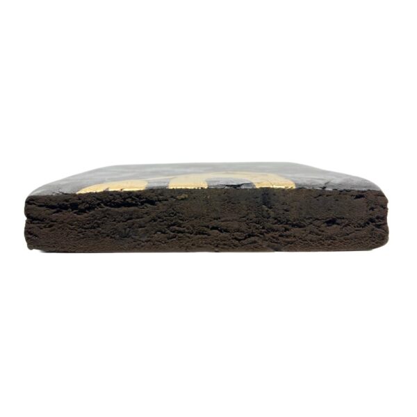 An image of Superman Hash cut in half showcasing the inside of the brick on a white background