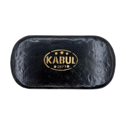 A round Afghan Kabul Hash brick with a gold embossed stamp on its dark surface, displayed on a white background.