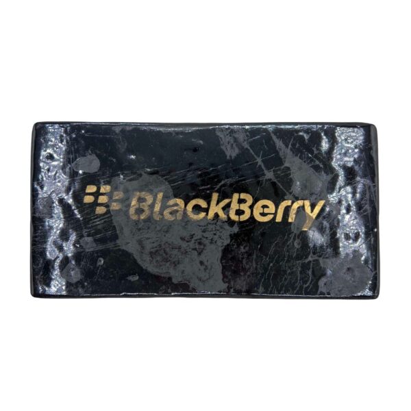 Blackberry Kush Hash brick with a dense, dark brown surface, stamped with a Blackberry phone logo, shown on a clean white background