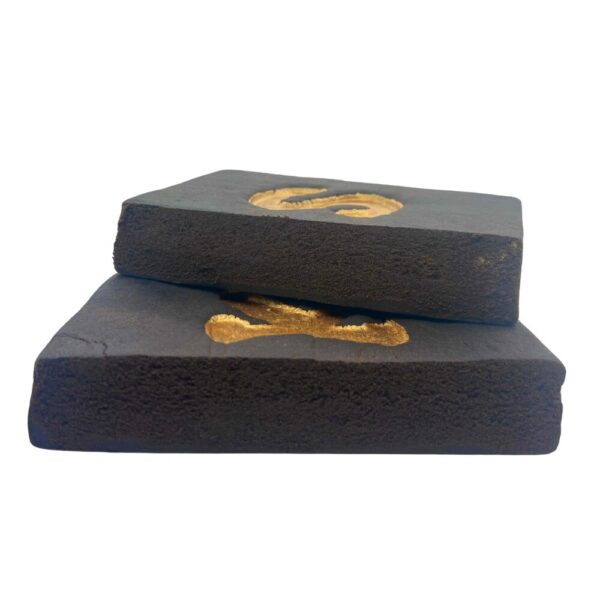 An image of 2 Strawberry Kush Hash blocks on their sides to showcase the inside texture of the hash